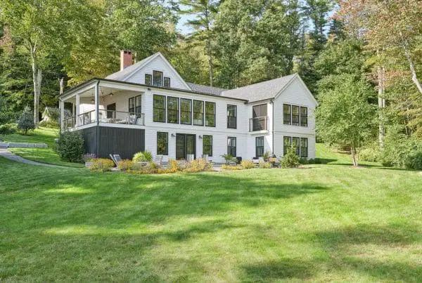 large three story white home build by a building contractor in Maine