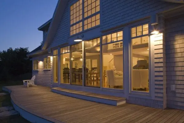 A modern home with a porch designed by a building contractor in southern Maine